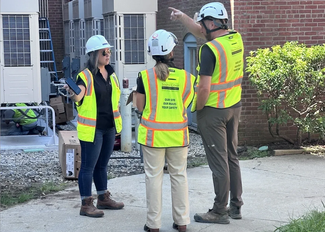 South Coast Improvement Company team planning work at a building